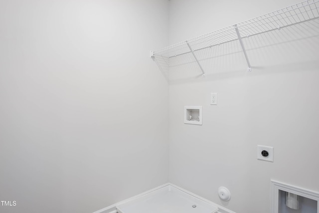 clothes washing area with hookup for a washing machine, electric dryer hookup, hookup for a gas dryer, and laundry area