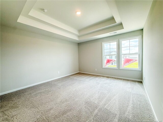 2224 Roadster Pony Rd, Hope Mills, NC 28348 - carpeted empty room featuring a tray ceiling and a smoke detector