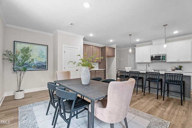 20 Diamond Creek Dr, Zebulon, NC 27597 - dining area featuring light wood-style floors, ornamental molding, and recessed lighting