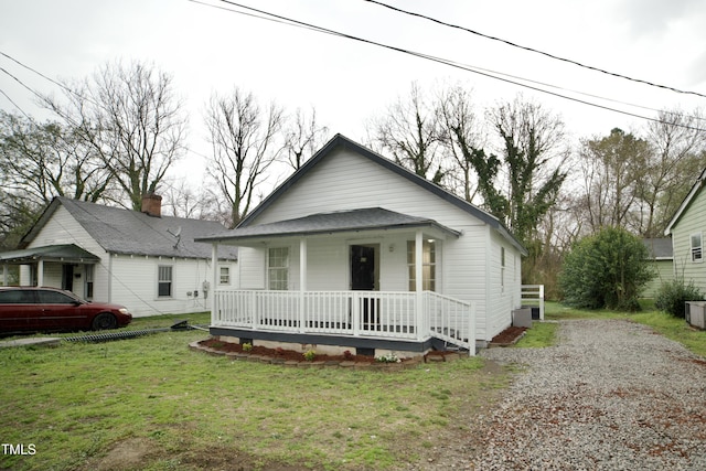 bungalow with a porch, driveway, and a front yard