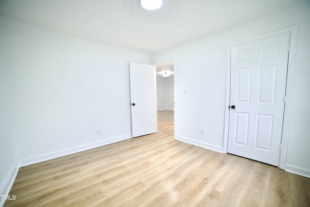 unfurnished bedroom with baseboards and light wood-style floors