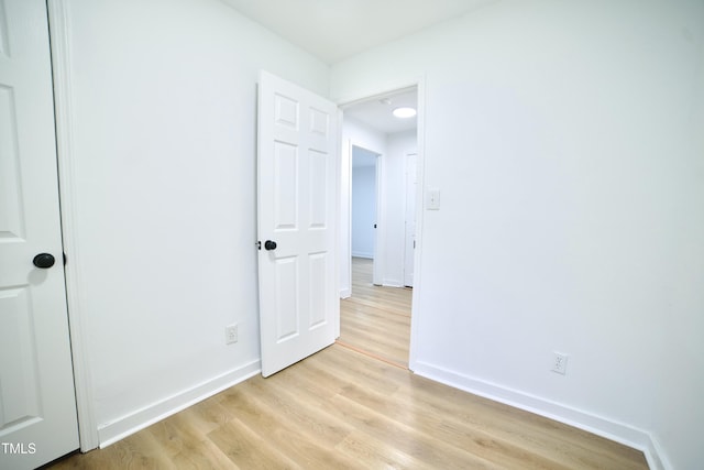 unfurnished bedroom featuring light wood-type flooring and baseboards
