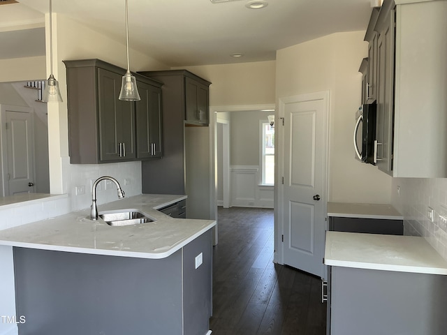 1039 N Lincoln St, Benson, NC 27504 - kitchen featuring a peninsula, decorative backsplash, stainless steel microwave, light countertops, and recessed lighting