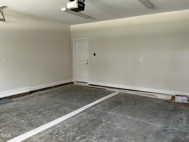 1039 N Lincoln St, Benson, NC 27504 - garage featuring a garage door opener and baseboards