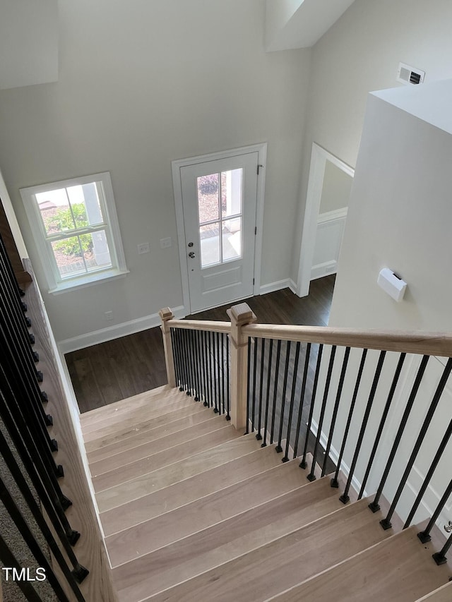 1039 N Lincoln St, Benson, NC 27504 - staircase featuring wood finished floors and a high ceiling