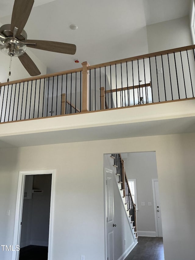 1039 N Lincoln St, Benson, NC 27504 - stairs featuring ceiling fan, a towering ceiling, and wood finished floors