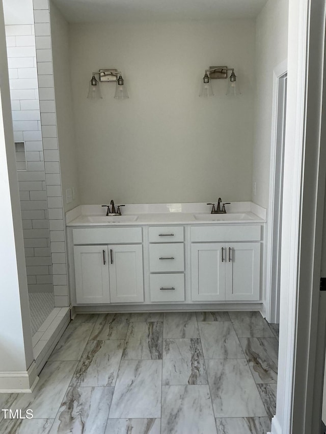 1039 N Lincoln St, Benson, NC 27504 - bathroom featuring a tile shower, marble finish flooring, and double vanity