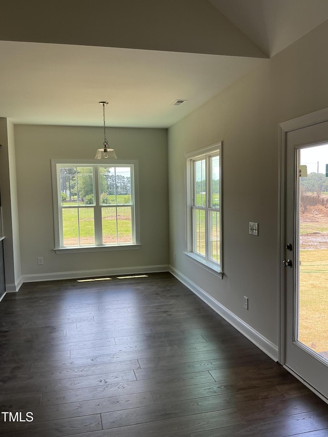 1039 N Lincoln St, Benson, NC 27504 - unfurnished dining area with baseboards and dark wood-type flooring