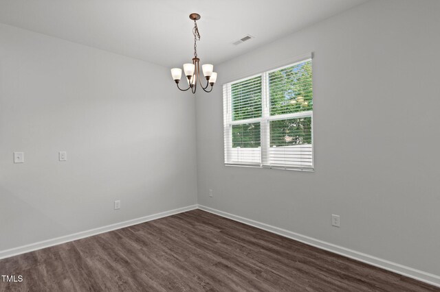 1028 Gallivant Way, Wake Forest, NC 27587 - unfurnished room featuring dark wood-style flooring, a chandelier, and baseboards