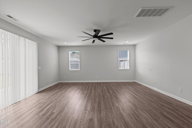1028 Gallivant Way, Wake Forest, NC 27587 - unfurnished room with plenty of natural light, dark wood finished floors, ceiling fan, and baseboards
