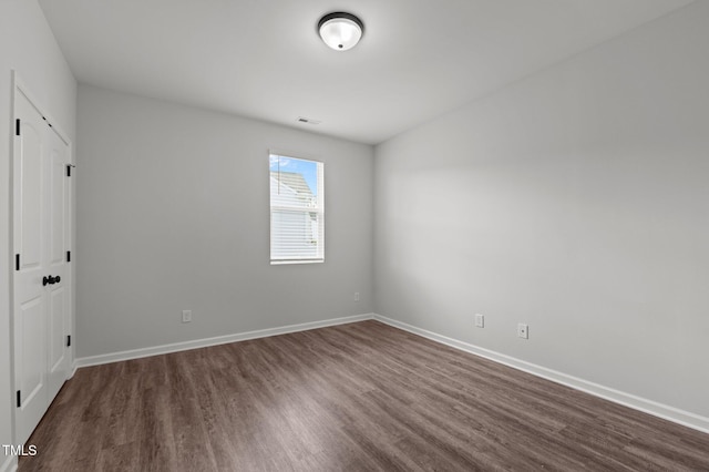 1028 Gallivant Way, Wake Forest, NC 27587 - unfurnished bedroom featuring dark wood-style floors and baseboards