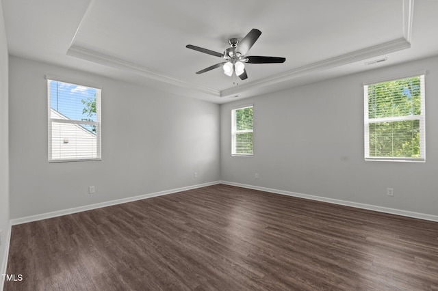 1028 Gallivant Way, Wake Forest, NC 27587 - empty room featuring a raised ceiling, healthy amount of natural light, dark wood-type flooring, and crown molding