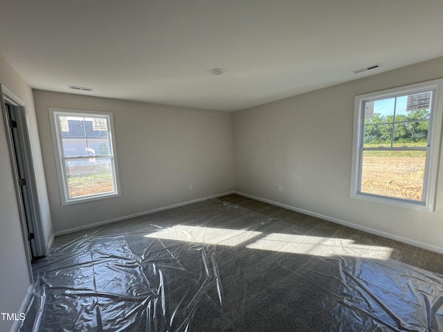 92 Dalton Dr, Lumber Bridge, NC 28357 - carpeted spare room featuring visible vents, baseboards, and plenty of natural light