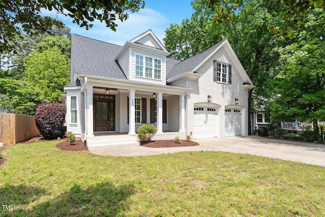 view of front of house with covered porch, a garage, fence, a front lawn, and concrete driveway