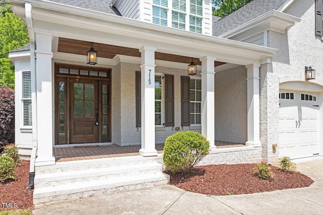 property entrance with roof with shingles, a porch, and driveway