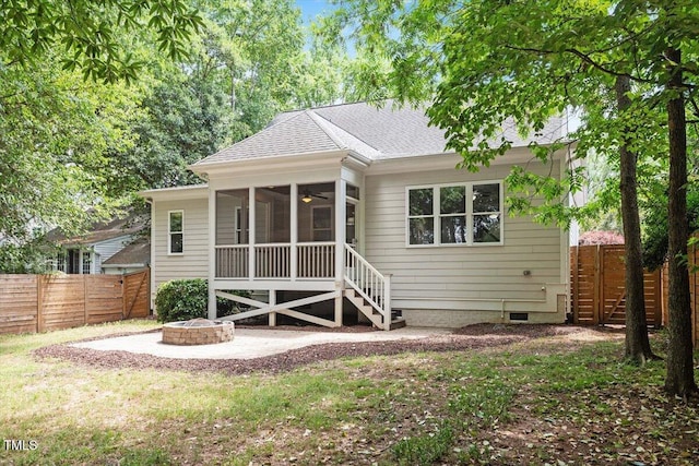 rear view of house featuring crawl space, fence, roof with shingles, and an outdoor fire pit