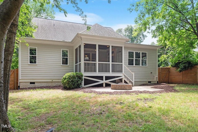 back of house with a yard, crawl space, and fence