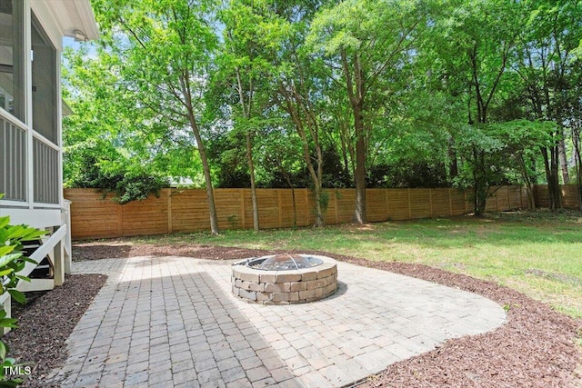 view of patio featuring a fenced backyard and an outdoor fire pit