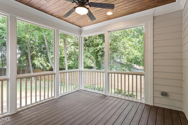 unfurnished sunroom featuring wooden ceiling, ceiling fan, and ornamental molding
