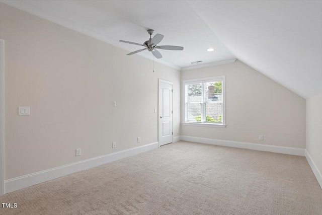 additional living space with vaulted ceiling, baseboards, light carpet, and a ceiling fan