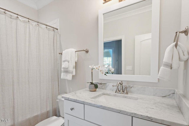 bathroom with vanity, ornamental molding, toilet, and shower / tub combo