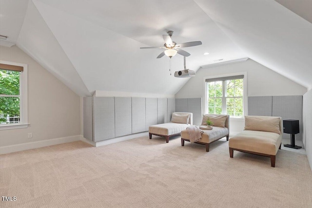 living area with carpet floors, a ceiling fan, baseboards, and lofted ceiling