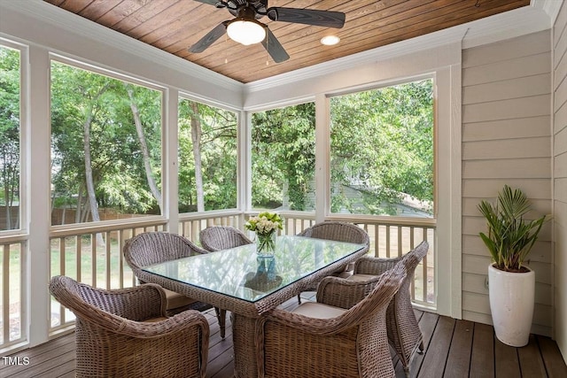 sunroom with plenty of natural light, a ceiling fan, and outdoor dining area