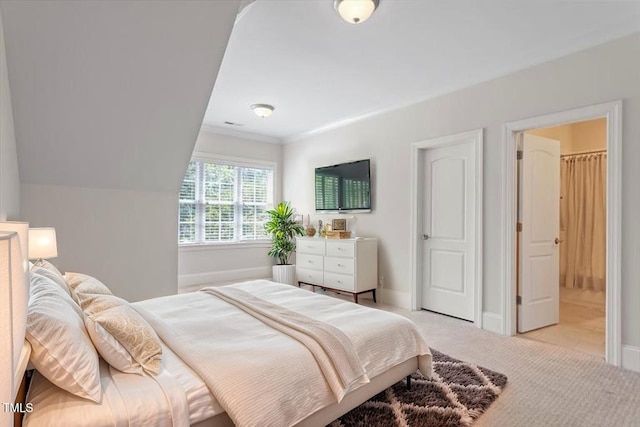bedroom featuring baseboards and light colored carpet