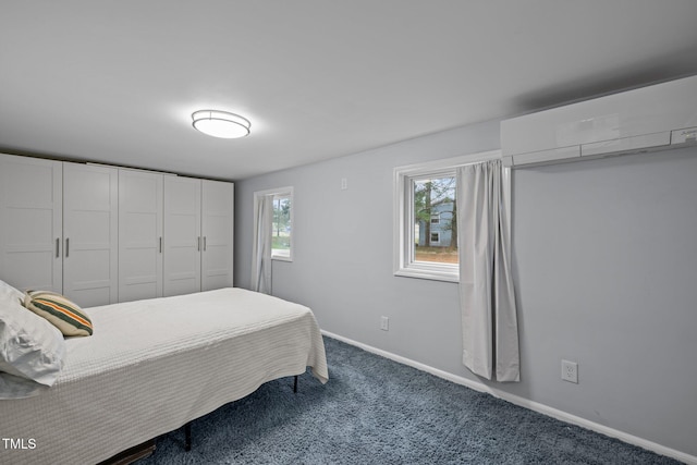 carpeted bedroom featuring baseboards