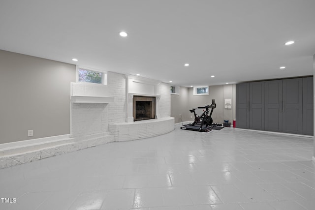 exercise area with a brick fireplace and recessed lighting