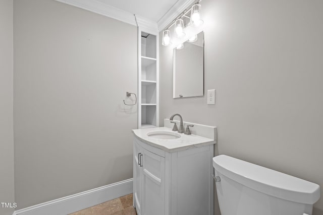 bathroom with baseboards, crown molding, toilet, and vanity