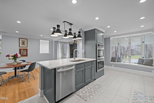 kitchen featuring crown molding, recessed lighting, a sink, gray cabinetry, and stainless steel appliances