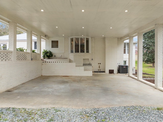view of patio with central AC unit and a carport