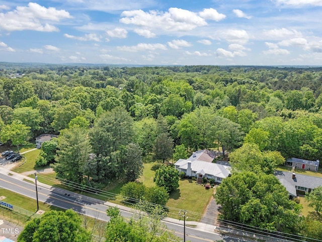 drone / aerial view featuring a forest view