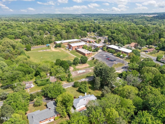birds eye view of property featuring a view of trees