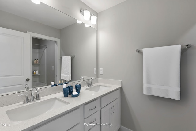 bathroom with double vanity and a shower