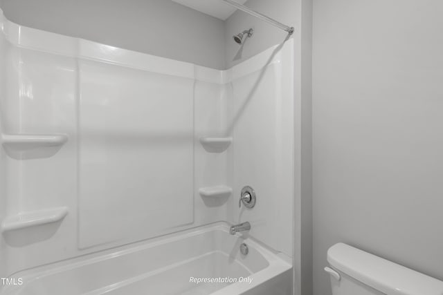 bathroom with toilet and bathing tub / shower combination