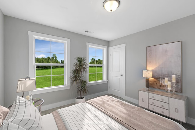 carpeted bedroom featuring baseboards