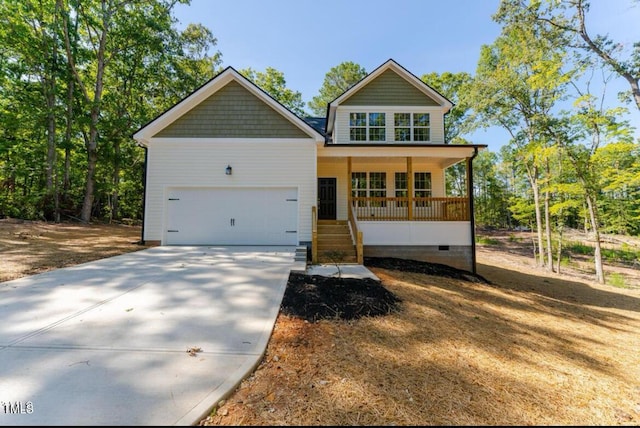 craftsman-style home featuring driveway, a porch, crawl space, and an attached garage