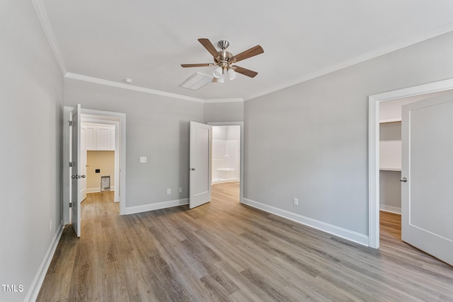 unfurnished bedroom featuring a ceiling fan, ornamental molding, baseboards, and wood finished floors