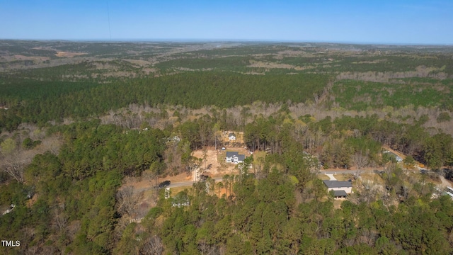 birds eye view of property with a wooded view