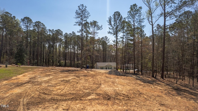 view of yard with a wooded view