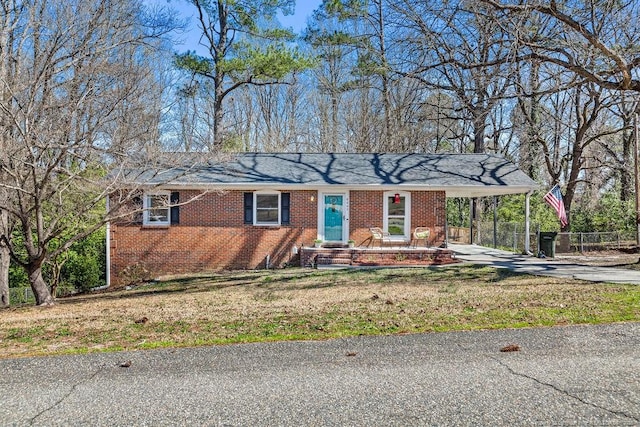 6407 Kimridge Rd, Fayetteville, NC 28314 - ranch-style home with brick siding, an attached carport, concrete driveway, and a front lawn