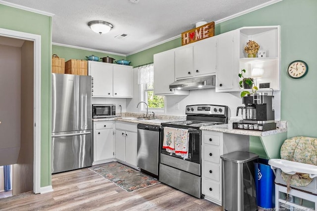 6407 Kimridge Rd, Fayetteville, NC 28314 - kitchen with under cabinet range hood, stainless steel appliances, crown molding, and light countertops