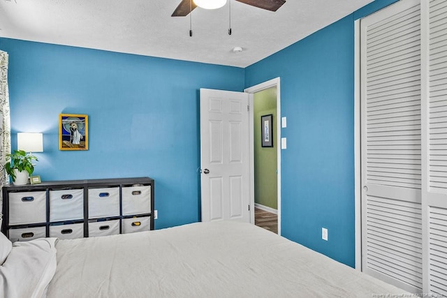 6407 Kimridge Rd, Fayetteville, NC 28314 - bedroom with a closet, baseboards, a textured ceiling, and ceiling fan