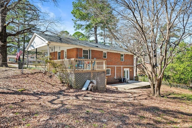 6407 Kimridge Rd, Fayetteville, NC 28314 - back of house with a deck, a patio, fence, and brick siding