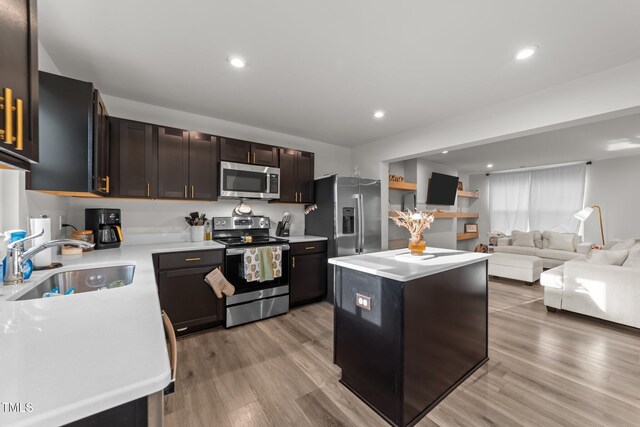 1558 Indigo Creek Dr, Zebulon, NC 27597 - kitchen featuring stainless steel appliances, light countertops, light wood-style floors, and a sink