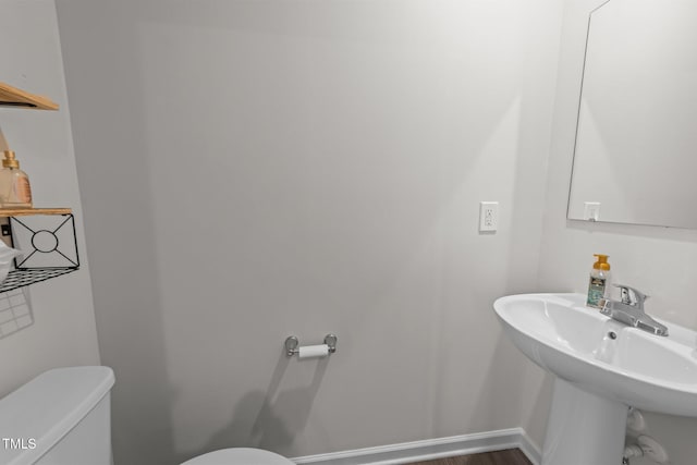 1558 Indigo Creek Dr, Zebulon, NC 27597 - bathroom featuring toilet, baseboards, and a sink