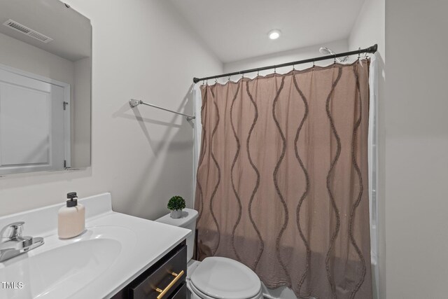 1558 Indigo Creek Dr, Zebulon, NC 27597 - full bath with visible vents, toilet, vanity, and a shower with shower curtain