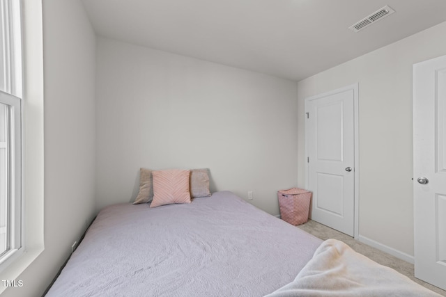 1558 Indigo Creek Dr, Zebulon, NC 27597 - bedroom with visible vents and light colored carpet
